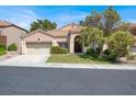 Charming single-story home featuring a well-manicured lawn, two-car garage and a welcoming entrance at 8612 Chiquita Dr, Las Vegas, NV 89128