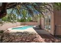 Inviting backyard pool surrounded by desert landscaping, a perfect outdoor relaxation space at 8612 Chiquita Dr, Las Vegas, NV 89128