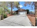 A single-Gathering house with an attached two-car garage and a spacious driveway at 872 N Linn Ln, Las Vegas, NV 89110