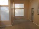 Bright living room with large windows and neutral carpet at 9709 Port Orange Ln, Las Vegas, NV 89134