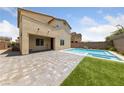 Inviting backyard pool and spa, perfect for relaxation and entertaining with a paved deck and privacy fence at 9839 Berkley Brook Ct, Las Vegas, NV 89141