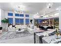 Open-concept living room features large windows with city views, modern lighting, and sleek finishes at , Las Vegas, NV 89135