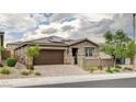 Inviting single-story home with desert landscaping, a tile roof, solar panels, and a two-car garage at 10182 Skye Run Ave, Las Vegas, NV 89166