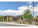 Beautiful single-story home with a two-car garage, desert landscaping, and solar panels at 10182 Skye Run Ave, Las Vegas, NV 89166