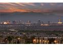 Enjoy breathtaking city and mountain views from this home, showcasing the vibrant cityscape lights at dusk at 1060 Calico Ridge Dr, Henderson, NV 89011