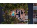Aerial view of home featuring a private pool, patio, desert landscaping, and solar panels at 10674 Chillingham Dr, Las Vegas, NV 89183