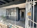 Inviting front porch with ornate security gate and a glimpse into the home's interior with marble-like tile at 1304 Bonita Ave, Las Vegas, NV 89104