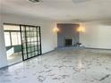Spacious living room with marble-like tile flooring and a decorative brick fireplace at 1304 Bonita Ave, Las Vegas, NV 89104
