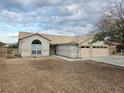 Neutral stucco home with a tile roof, a two-car garage, and clean desert landscaping at 1345 N Hollywood Blvd, Las Vegas, NV 89110