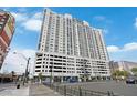 Multi-story condominium with stunning architectural appeal set against a partly cloudy sky at 150 Las Vegas Blvd # 1004, Las Vegas, NV 89101