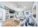 Cozy living room with vaulted ceiling, fireplace, shelving, and natural light from the sliding glass doors at 155 Fallon Dr, Henderson, NV 89074