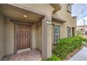 Inviting front entrance featuring a decorative brown door with brick walkway and neatly trimmed landscaping at 173 Petaluma Valley Dr, Las Vegas, NV 89138