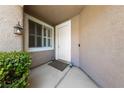 Welcoming front entrance featuring a stylish light fixture, shuttered window, and clean white door at 1912 Summer Pine Ct # 102, Las Vegas, NV 89134