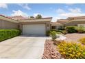 Inviting single-story home with a two-car garage and colorful, desert-friendly landscaping at 1912 Summer Pine Ct # 102, Las Vegas, NV 89134
