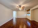 Spacious living room featuring hardwood floors, a ceiling fan, and natural light at 1995 Sundown Canyon Dr, Henderson, NV 89014