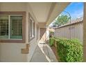 Inviting entryway showcasing a covered porch with neutral stucco and dark trim accents at 2328 Fossil Canyon Dr, Henderson, NV 89052