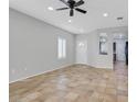 Bright living room featuring tile floors, and a pass through to the kitchen and dining area at 2328 Fossil Canyon Dr, Henderson, NV 89052