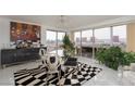 Dining area with modern table set and access to living area and city views at 3111 Bel Air Dr # 12G, Las Vegas, NV 89109
