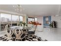 Open-concept dining room with a modern table set that flows into the living area and overlooks the city at 3111 Bel Air Dr # 12G, Las Vegas, NV 89109