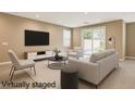 Bright living room features neutral tones, modern furniture, and sliding glass doors to the backyard at 3760 Paseo De Paz Ave, Las Vegas, NV 89115