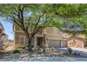 Two-story home with manicured yard, desert landscaping, and two-car garage at 4225 Telstar Ct, North Las Vegas, NV 89032