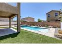 Backyard pool and spa with desert landscaping on an artificial turf surround at 4225 Telstar Ct, North Las Vegas, NV 89032