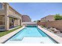 Backyard pool and spa with low maintenance desert landscaping on artificial turf at 4225 Telstar Ct, North Las Vegas, NV 89032