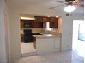 Functional kitchen features dark cabinetry and opens to the breakfast nook and living area at 5006 Schumann Dr, Las Vegas, NV 89146