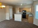 Well-equipped kitchen with an island, granite countertops, and stainless steel appliances at 5307 Wild Orchid St, North Las Vegas, NV 89031