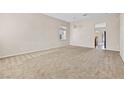 Spacious living room with neutral carpet, ample natural light, and a modern, open layout at 5307 Wild Orchid St, North Las Vegas, NV 89031