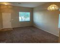 Cozy living room featuring neutral paint, large window and carpet at 5307 Wild Orchid St, North Las Vegas, NV 89031