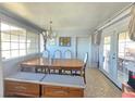 Cozy dining room with an elegant table, seating for six, and access to the outdoors at 5704 Heron Ave, Las Vegas, NV 89107