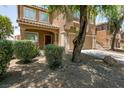 Charming two-story house with desert landscaping and an attached two-car garage at 5835 Running Horse Dr, North Las Vegas, NV 89081