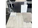 Selection of modern finishes with wood-look flooring, granite countertop, and carpet samples at 5870 Kips Bay St, Las Vegas, NV 89148