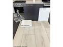 Sample of material selections with gray flooring, cabinets, countertops, and sleek chrome faucet at 5870 Kips Bay St, Las Vegas, NV 89148