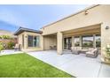 An outdoor oasis with a seating area, a manicured lawn, and a covered patio at 6728 Regency Ridge Ct, Las Vegas, NV 89148