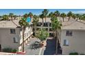 Exterior of a multi-story condo building with palm trees in a well maintained community at 7119 S Durango Dr # 211, Las Vegas, NV 89113