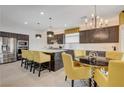 Spacious kitchen featuring stainless steel appliances, a kitchen island, and a dining area at 7208 Grace Estate Ave, Las Vegas, NV 89113