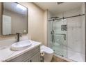 Contemporary bathroom with marble walk-in shower, stylish vanity, and modern toilet at 7477 Ullom Dr, Las Vegas, NV 89139