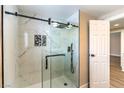 Marble tiled walk-in shower with sliding glass door and sleek matte black hardware at 7477 Ullom Dr, Las Vegas, NV 89139