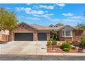 Charming brick home featuring a three-car garage, landscaped front yard, and a beautiful bay window at 8504 Mystic Night Ave, Las Vegas, NV 89143