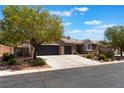 Charming brick home featuring a three-car garage, landscaped front yard, and mature shade trees at 8504 Mystic Night Ave, Las Vegas, NV 89143