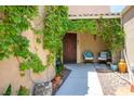 Welcoming covered porch with climbing vines, seating, and decorative pots at 8873 Briar Bay Dr, Las Vegas, NV 89131