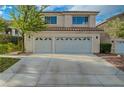 Exterior view showcasing a three-car garage with decorative windows at 9772 Galahad Point Ct, Las Vegas, NV 89147