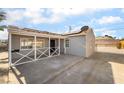Inviting single-story gray home with a covered front porch and a spacious driveway at 113 Elm St, Henderson, NV 89015