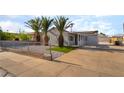 Gray single-story home with desert landscaping, palm trees, and an extended, covered front porch at 113 Elm St, Henderson, NV 89015