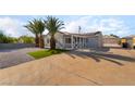 Quaint gray single-story home with solar panels and desert landscaping in a sunny location at 113 Elm St, Henderson, NV 89015