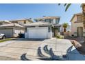 Beautiful two-story house featuring a well-maintained lawn, two-car garage, desert landscaping, and tile roof at 1352 Angel Falls St, Las Vegas, NV 89142