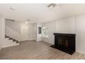 Cozy living room with modern flooring, a charming fireplace, and newly painted walls at 1704 Kismet Cir, Las Vegas, NV 89108