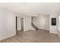 Bright living room featuring new flooring, a staircase, a closet, and fresh paint for a modern feel at 1704 Kismet Cir, Las Vegas, NV 89108